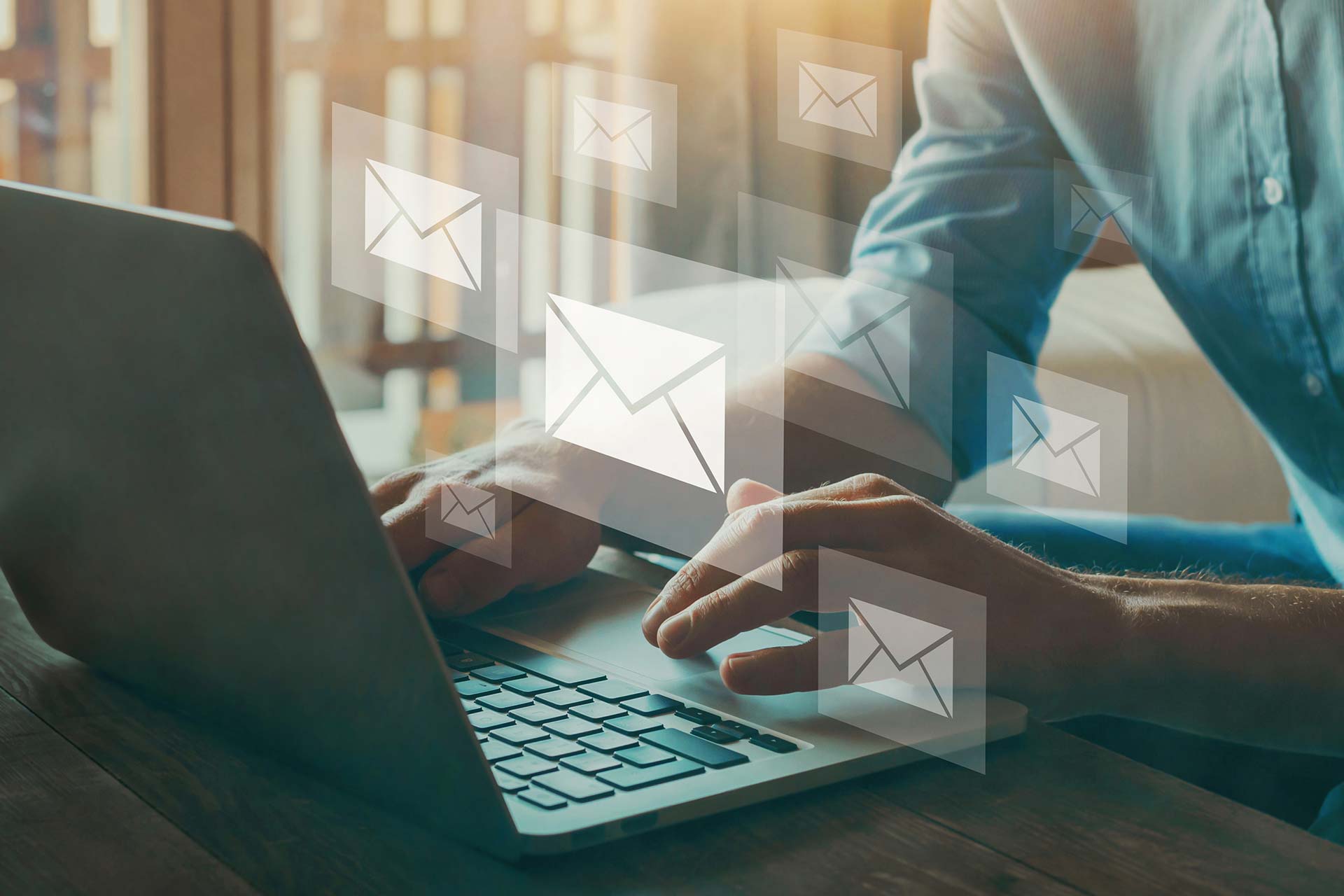 Email Marketing Visual male at laptop with email icons overlayed